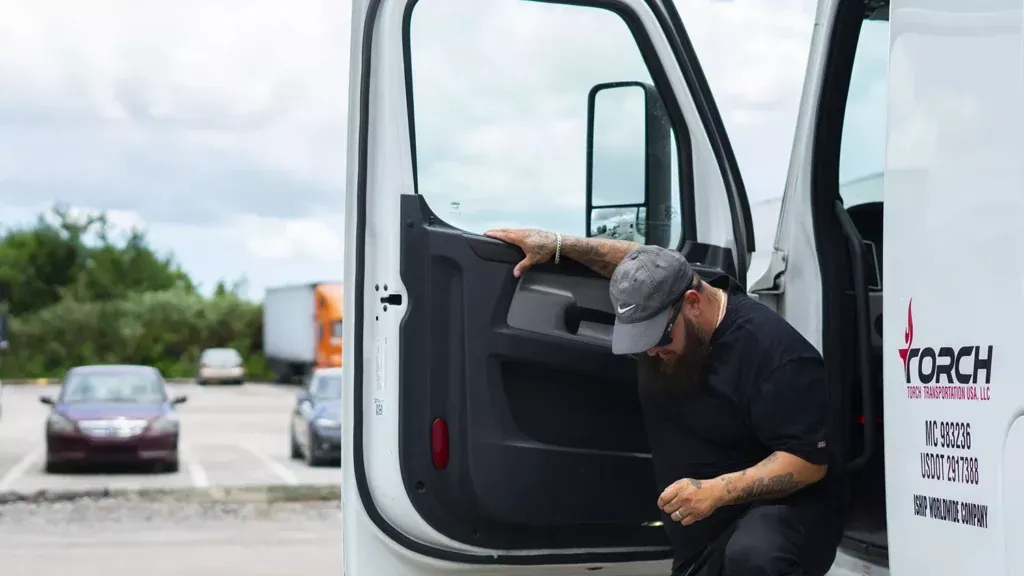 man in hat getting out of truck